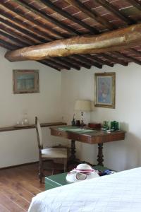 a bedroom with a desk and a table with a chair at Torre Di Sant'Ansano in Corsano +44 photos