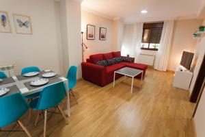 un soggiorno con divano rosso e tavolo di Apartamento Monachil Pueblo a Monachil