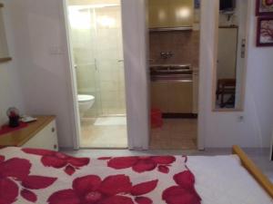 a bathroom with a bed and a bathroom with a shower at Apartments Ada Novak in Hvar