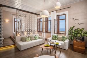 a living room with a couch and a table at Ambassadors Residence Boutique Hotel in Chania Town