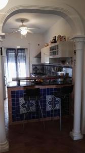 a kitchen with a counter with blue and white tiles at Casa Testa in Formia