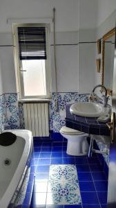 a bathroom with a tub and a toilet and a sink at Casa Testa in Formia