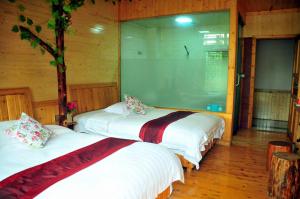 Cama o camas de una habitación en Yangjiajie Inn