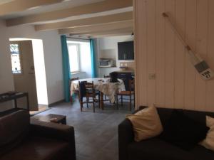 a living room with a table and a dining room at Maison de charme kertugal in Saint-Quay-Portrieux +1 photo