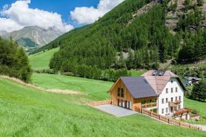 a house in the middle of a green field at Josephus in Senales