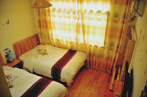 Cama o camas de una habitación en Yangjiajie Inn