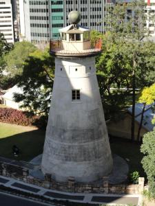 a lighthouse sitting in the middle of a city at Madison Tower Mill Hotel in Brisbane