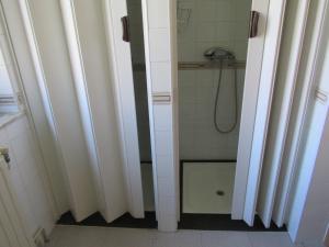 a bathroom with a shower and a glass door at Albergue De Oneta in Oneta