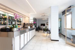 a bar in a room with a counter and chairs at Hotel Abruzzo in Pineto