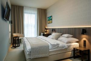 Postel nebo postele na pokoji v ubytování Hotel Rajka