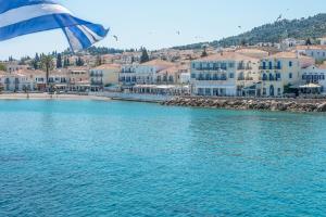 a view of a beach with houses and the water at Klimis Hotel in Spetses