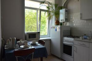 ブリャンスクにあるApartment on Prospekt Lenina 10のキッチン(テーブル、白い冷蔵庫付)