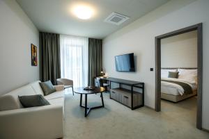 a hotel room with a bed and a mirror at Hotel Rajka in Valašské Meziříčí