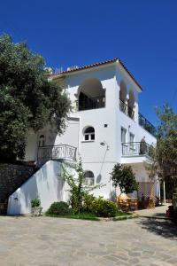 a white building with balconies on top of it at Nina Areti in Skiathos