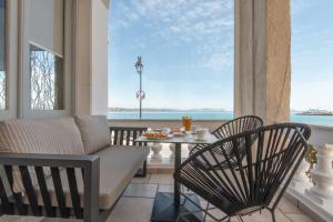 a living room with a couch and a table at Klimis Hotel in Spetses