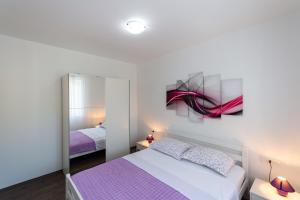 Postel nebo postele na pokoji v ubytování Green Paradise Apartments
