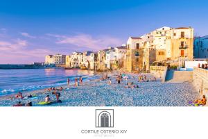 a group of people on a beach near the water at Cortile Osterio XIV in Cefalù