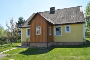 una pequeña casa amarilla con techo gris en Gasthof Speneder en Altpölla