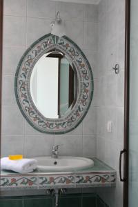 a bathroom with a sink and a mirror at Makedos Sea View in Nea Vrasna +152 photos