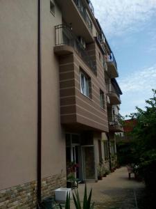a tall building with balconies on the side of it at Fits Guest House in Primorsko