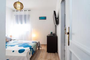 Posteľ alebo postele v izbe v ubytovaní Marina House Corralejo Center