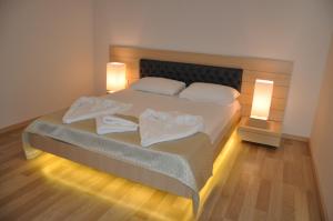 a bedroom with a bed with two towels on it at Boutique Suite Mim-A in Antalya