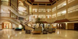 a large lobby with a spiral staircase in a building at The Lagoona Resort in Lonavala