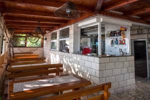 a row of benches sitting in front of a bar at Poseydon Beach Bungalow in Mlini +21 photos