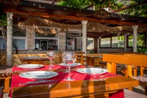 a wooden table with glasses and plates on it at Poseydon Beach Bungalow in Mlini