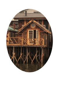 a round picture of a house on a pier at Palafito Ayün in Castro