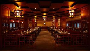 a large room with tables and chairs in a restaurant at JP Chennai Hotel in Chennai