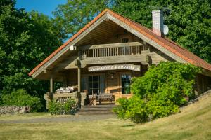 a log cabin with a bench in front of it at Kangru Holiday Home in Vanamõisa