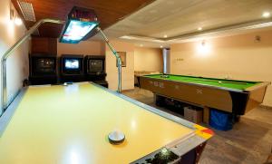 a room with a pool table and a tv at The Lagoona Resort in Lonavala