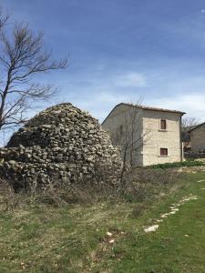 a large pile of rocks next to a building at Pezzelelle in Roccamorice