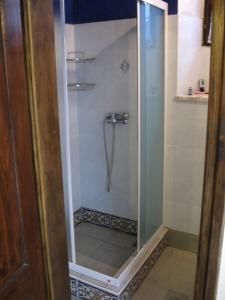 a shower with a glass door in a bathroom at COOL SUMMER ReTREAT in Susak