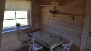 a dining room with a table and two chairs at Vienkiemis prie Merkinės in Merkinė
