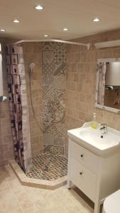 a bathroom with a shower with a sink and a sink at Vienkiemis prie Merkinės in Merkinė