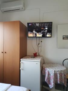 A television and/or entertainment centre at Efstathiou Mihail Studios and Apartments