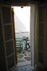an open door to a room with a table at Ostria in Naousa
