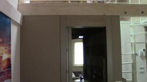 een hoogslaper in een kamer met een deur naar een hal bij Casa Bella in Verona
