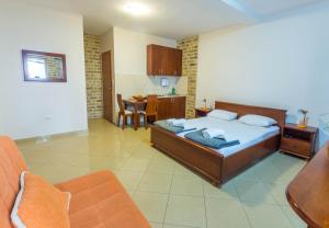 a large bedroom with a bed and a kitchen at Contessa Apartments in Budva