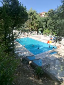 a large swimming pool with people in it at Gaiano Apt in Sorrento