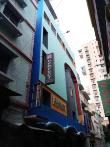a blue building with signs on the side of it at Perfect Guest House in Chennai