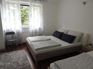 a bedroom with a bed and a window at Roses in Bihać