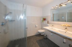 a bathroom with a shower and a sink and a toilet at Gasserhof Garni & Apartment in Schenna +91 photos