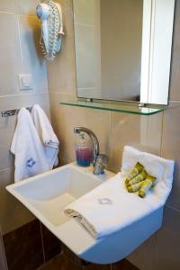 a white sink in a bathroom with a mirror at Alykes in Marmari