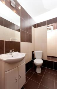 a bathroom with a white toilet and a sink at Janina in Pobierowo