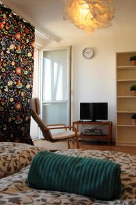 a living room with a couch and a tv at Panorama Prague Castle in Prague