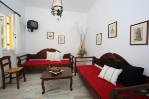 a living room with two couches and a table at Ostria in Naousa