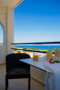 a room with a table and a view of the ocean at Alykes in Marmari